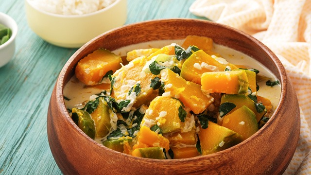 ginataang kalabasa with malunggay in a wooden bowl