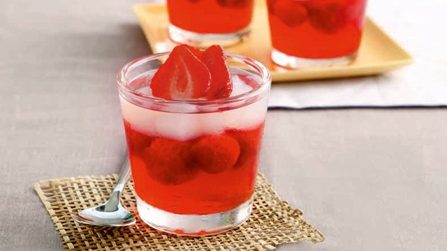 summer gelatin dessert with trawberries in a clear glass cup