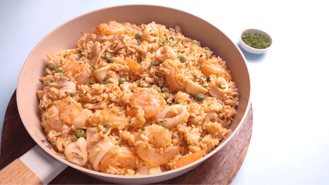creamy seafood paella in a pan