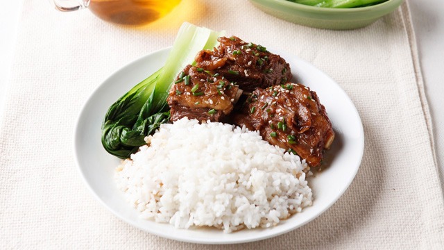 Easy Chinese Braised Beef Brisket with rice and bok choy on a white plate