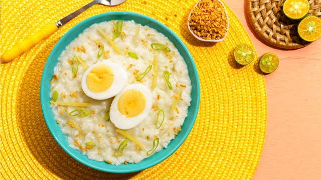 lugaw with egg topshot on a bright yellow placemat