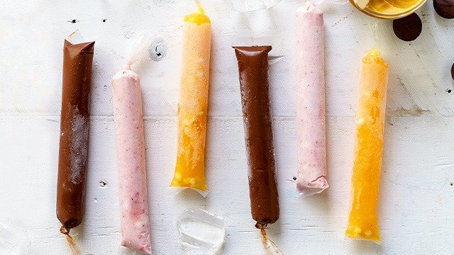 alternating chocolate peanut butter ice candy, strawberry cheesecake ice candy, melon white chocolate recipe on a table