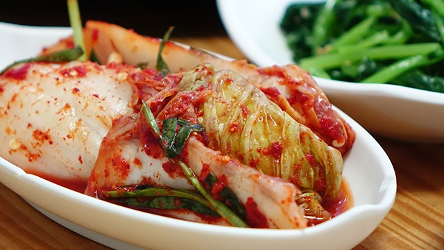 cabbage kimchi in a long narrow serving dish