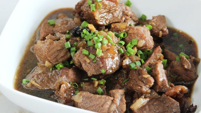 beef pares in a white bowl