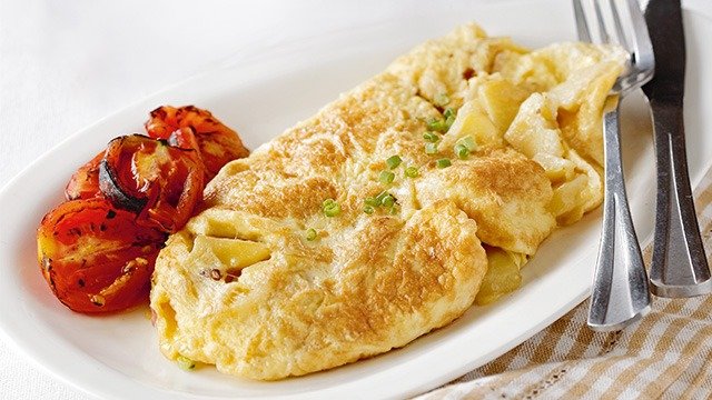 potato omelet with roasted tomatoes on the side