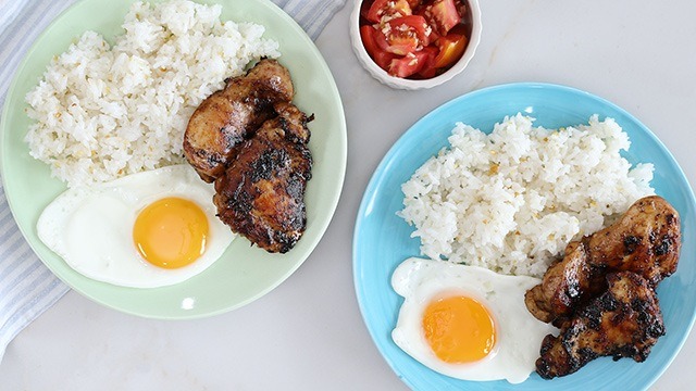 homemade chicken tocino on a blue and green plates