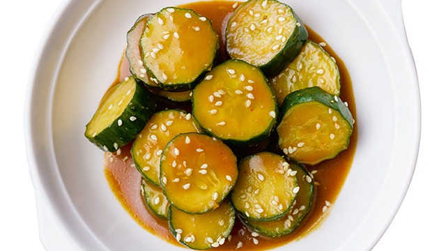 stir-fried zuccini with sauce in a white shallow bowl