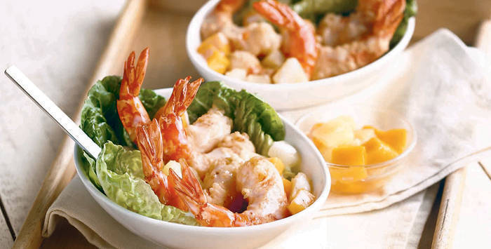 hot prawn salad with mangoes and pineapple in bowls