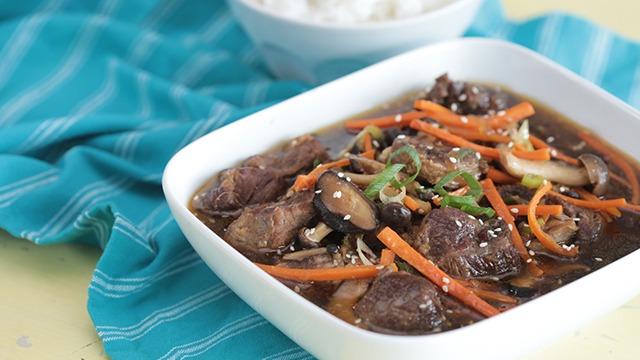 korean beef stew with mushrooms in a square serving bowl