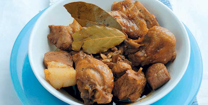 classic chicken and pork adobo in a white bowl