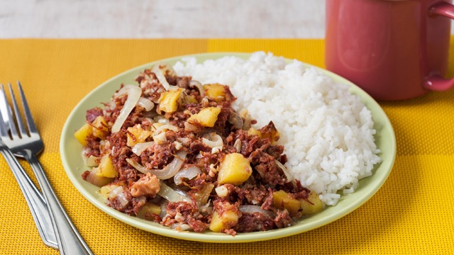 ginisang corned beef with rice on a green plate