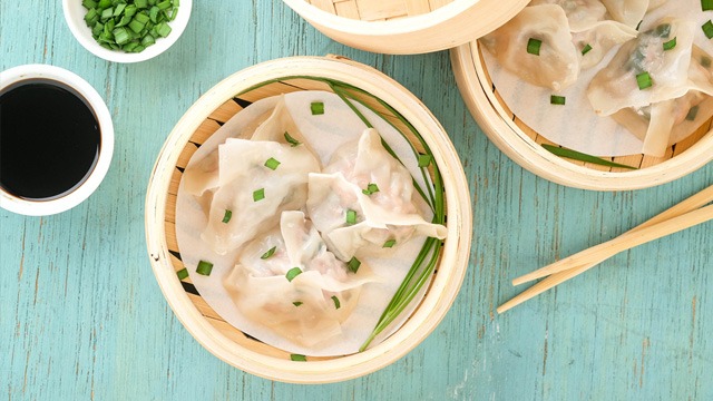 pork and chives orkuchay dumplings in a bamboo basket