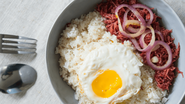 delicious morning breakfast corned beef with egg on top of rice