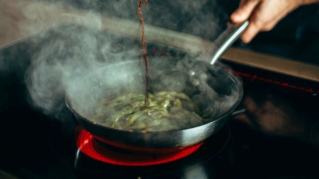 Stir fried noodles being cooked on an induction cooker