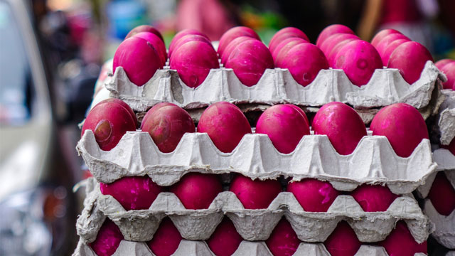 red salted eggs or itlog na pula stacked in egg tray cartons