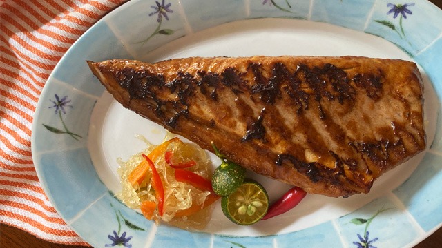 sinigang flavored tuna belly with grill marks on a plate with blue patterned frame