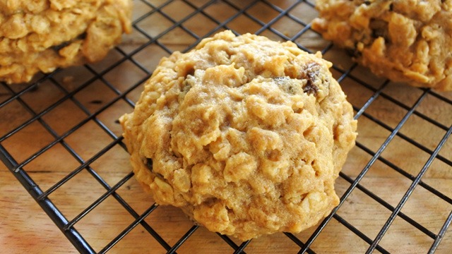 oatmeal cookies on a cooling rack against wood background
