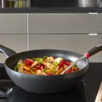Tefal nonstick wok with vegetables in kitchen