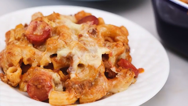 baked macaroni recipe image with ground meat tomato sauce topped with melty cheese