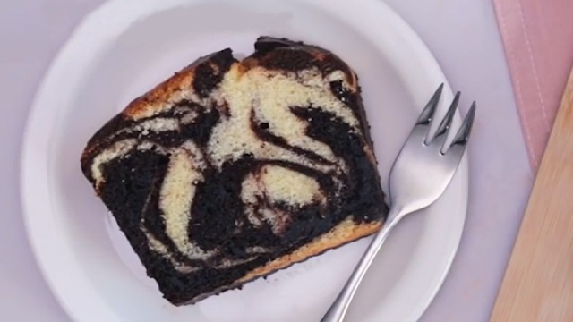 marble loaf cake slice on a plate with a fork