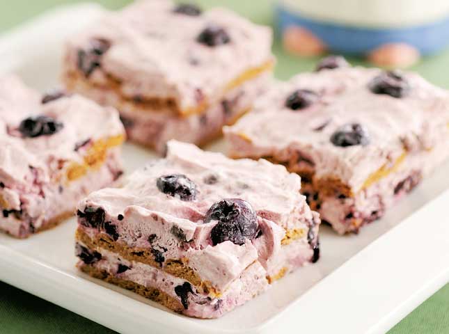 Refrigerated graham cake recipe that features frozen blueberries and whipped cream.