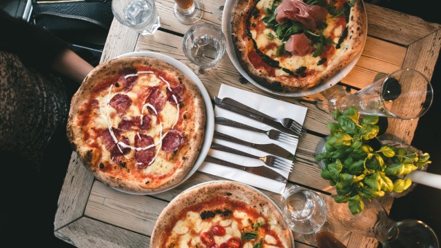 eating out with pizza on wooden dining table