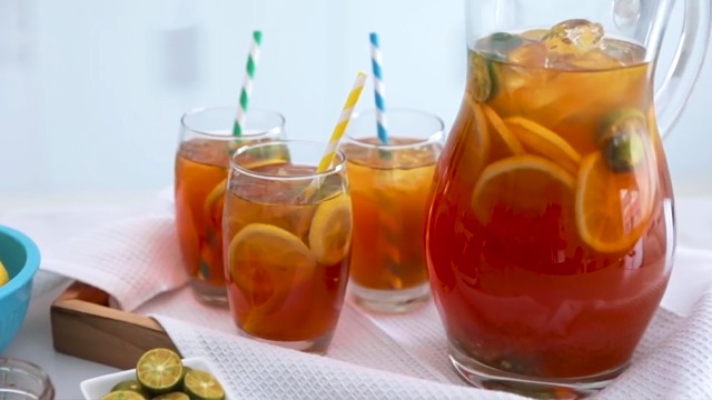 iced tea recipe in glasses with straws and a pitcher with lemon calamansi and honey