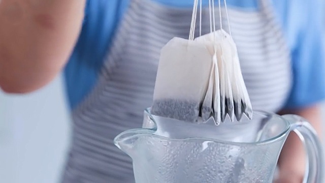 tea bags ready to be placed into a pitcher with water