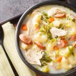 milky soup with macaroni, chicken, carrots, sausage, and greens is called "sopas"