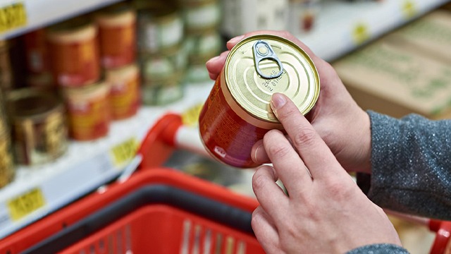 grocery shopping with hands holding canned food