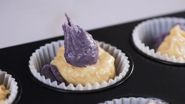 ube and cheese cupcake batters in one cupcake liner