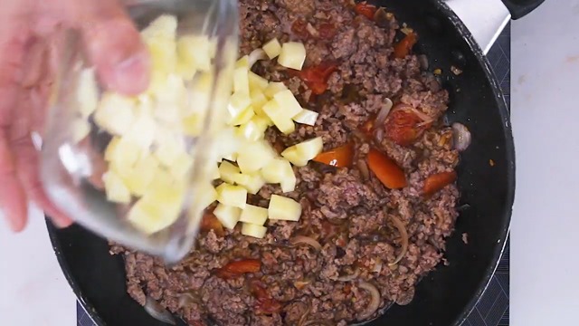 adding potatoes to ground meat mixture