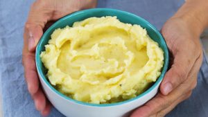 mashed potatoes in a bowl with hands