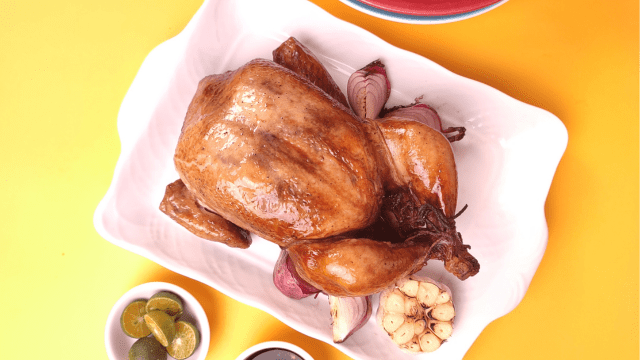 turbe broiler chicken on a rectangular plate and a yellow background
