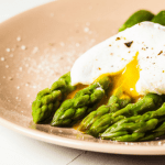 asparagus and soft boiled egg on a plate