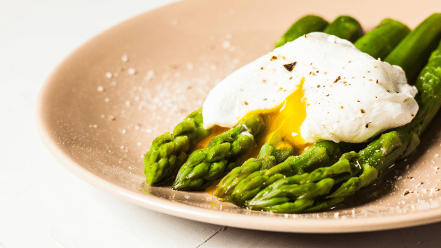 asparagus and soft boiled egg on a plate