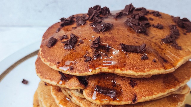 closeup of choco malt pancakes stacks with crushed chocolate and pancake syrup