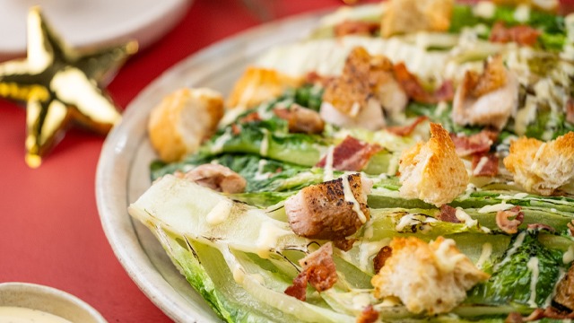 grilled caesar salad with grilled chicken and croutons close up