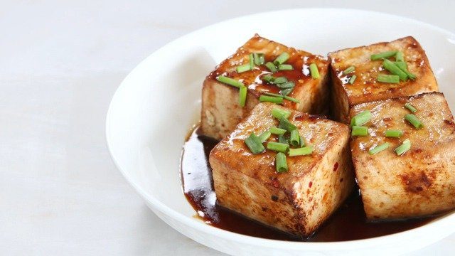 marinated tofu in a white bowl